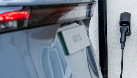 Electric car connected to a wall-mounted home charger